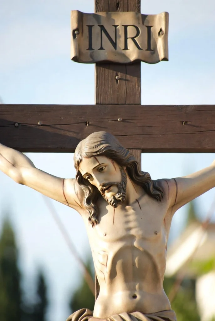 Jesus Christ on the cross with INRI sign above, symbolizing His sacrifice for Easter - a solemn and meaningful Christian wallpaper